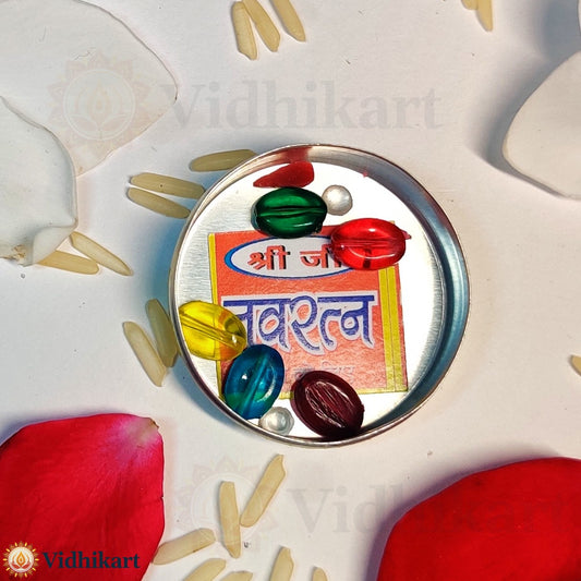 Decorative item with colorful beads and a card on a white background with red petals.